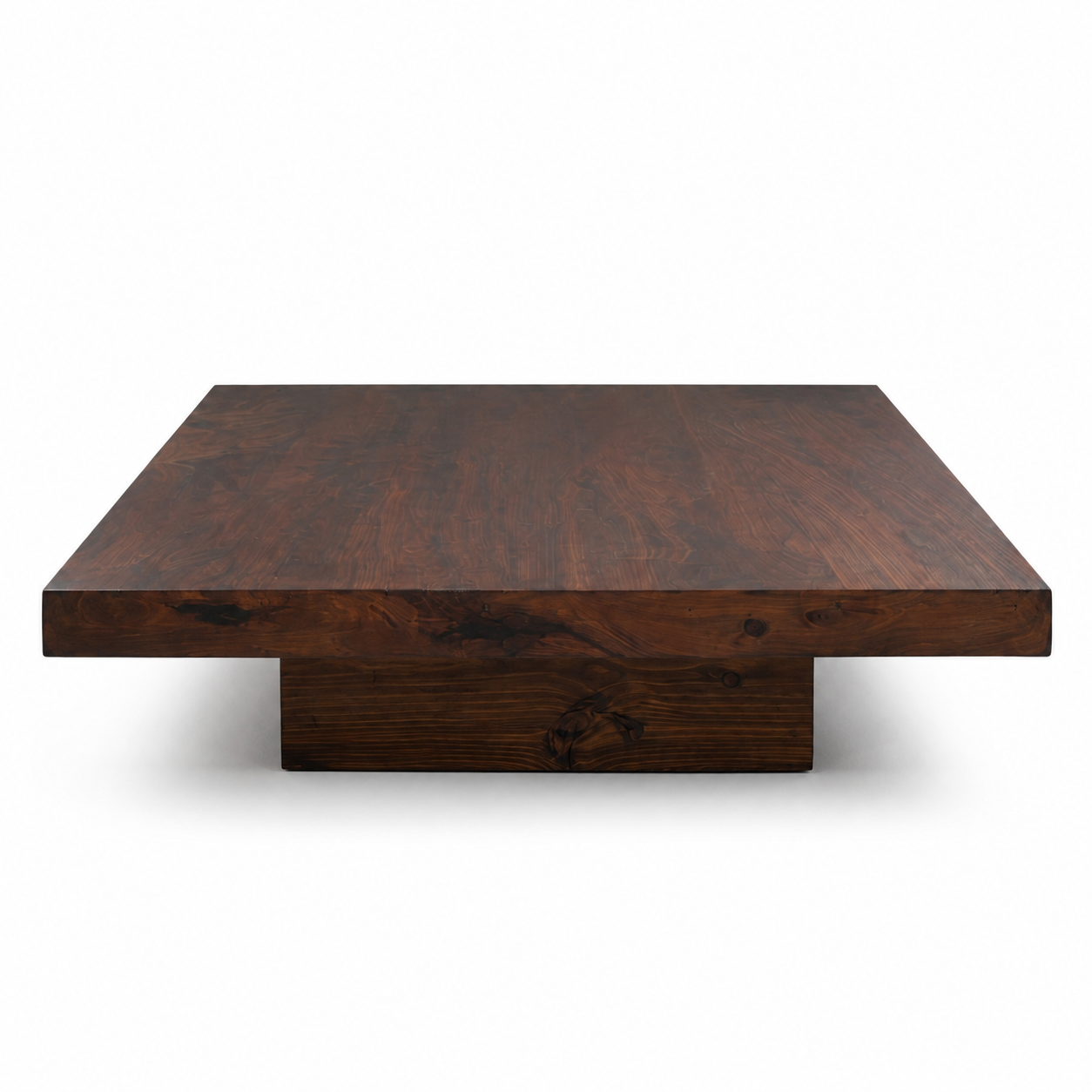 Sculptural plinth coffee table in dark wood on a white background by RJMCLEAN