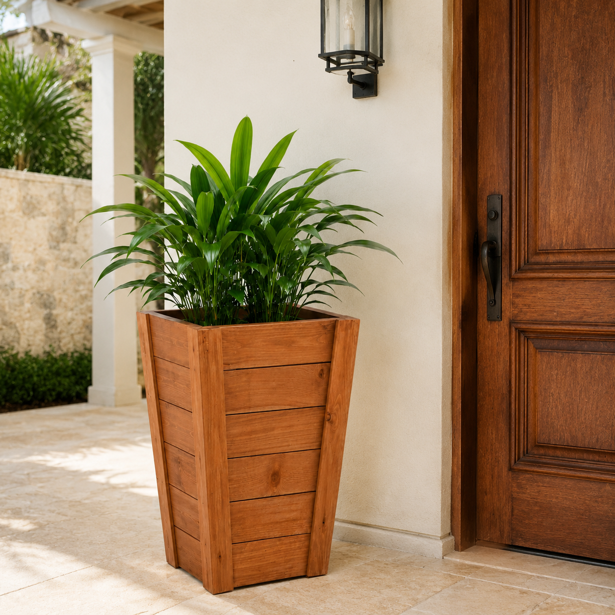 RISE tall tapered wooden planter styled beside the entrance of a Caribbean villa