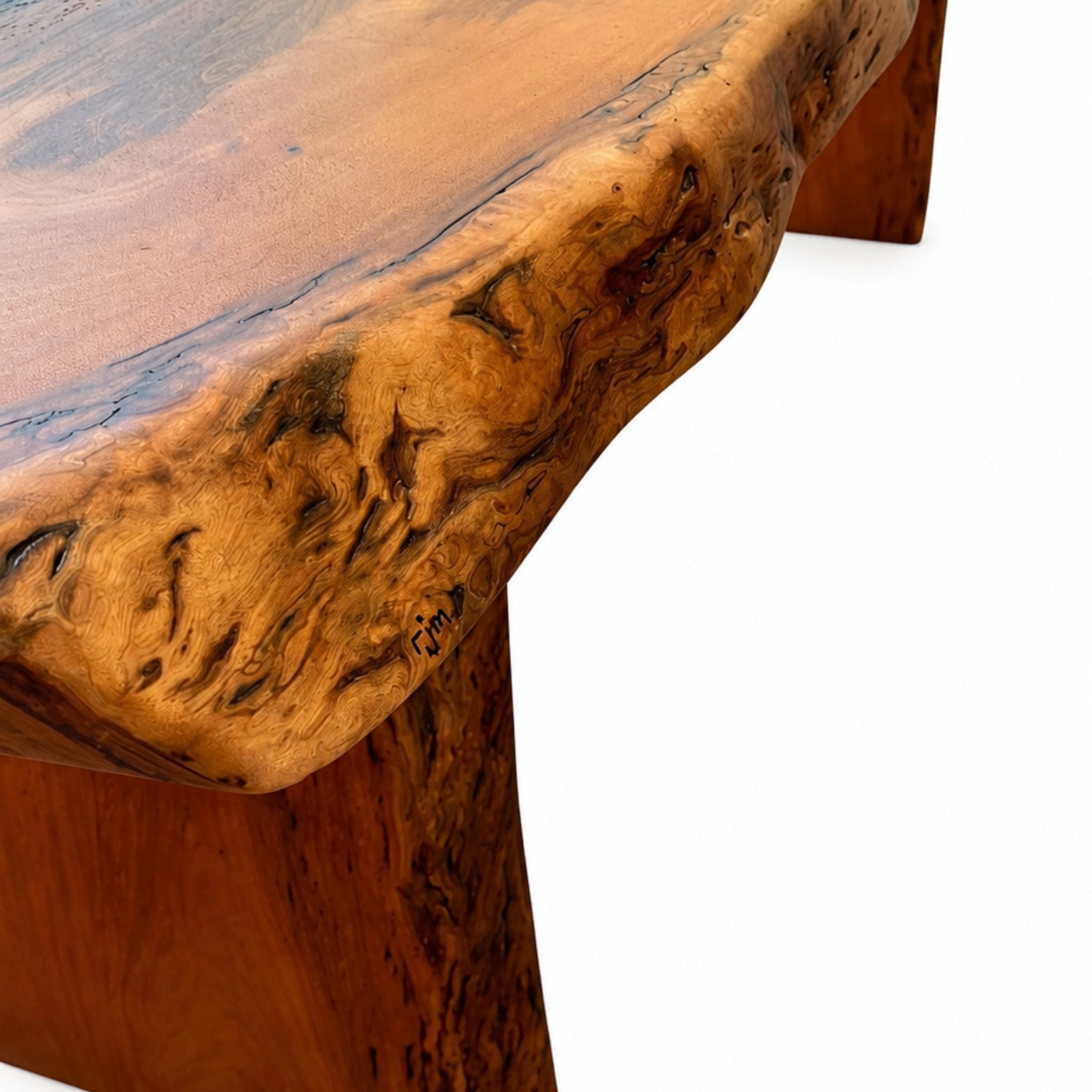 Close-up of handcrafted mahogany dining table showing rich wood grain and sculpted live edge